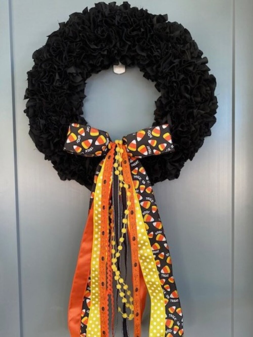 Halloween inspired Black Fabric Wreath with Candy Corn Bow.